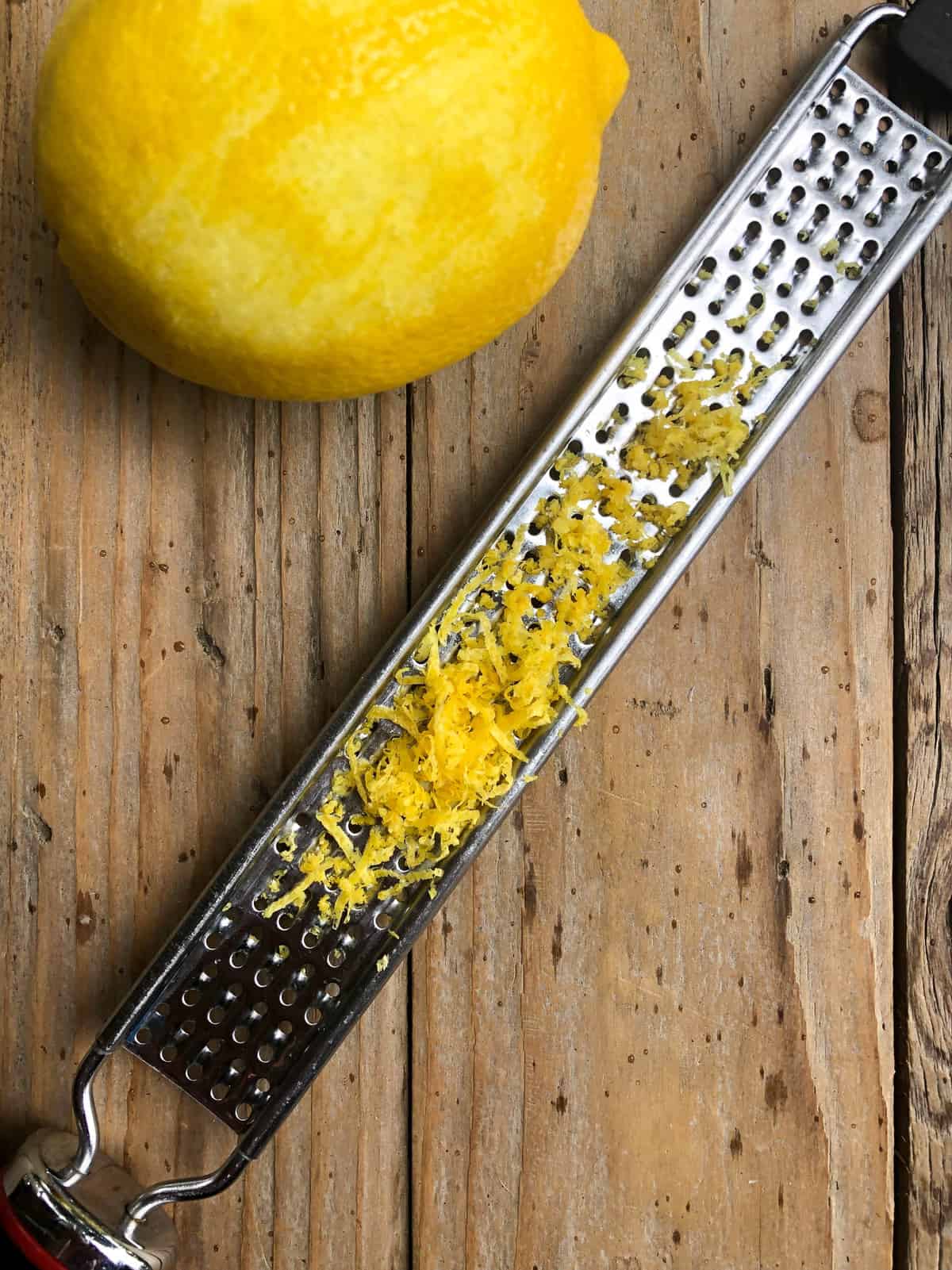 Zest one lemon and crush a few cloves of garlic and set aside.