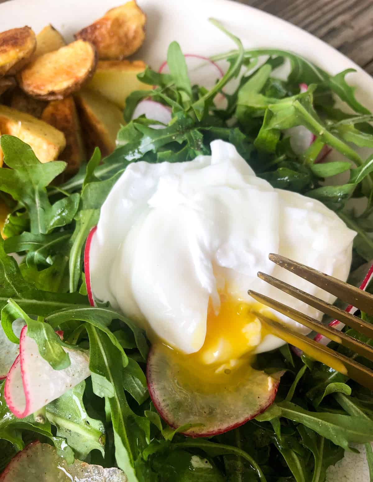 Place the poached egg right on top of the salad and pierce with a fork to let all that goodness ooze onto the plate
