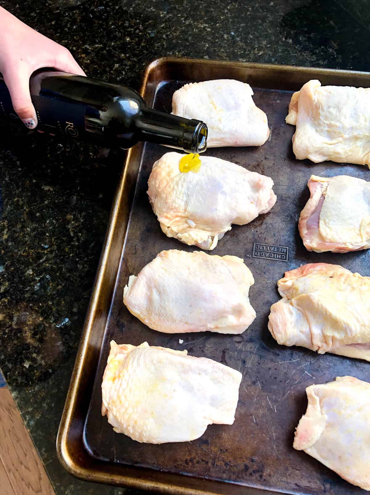 Pour olive oil over chicken