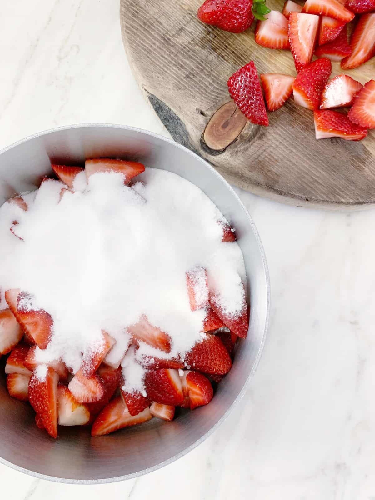 In a medium saucepan, combine strawberries, sugar, and water.
