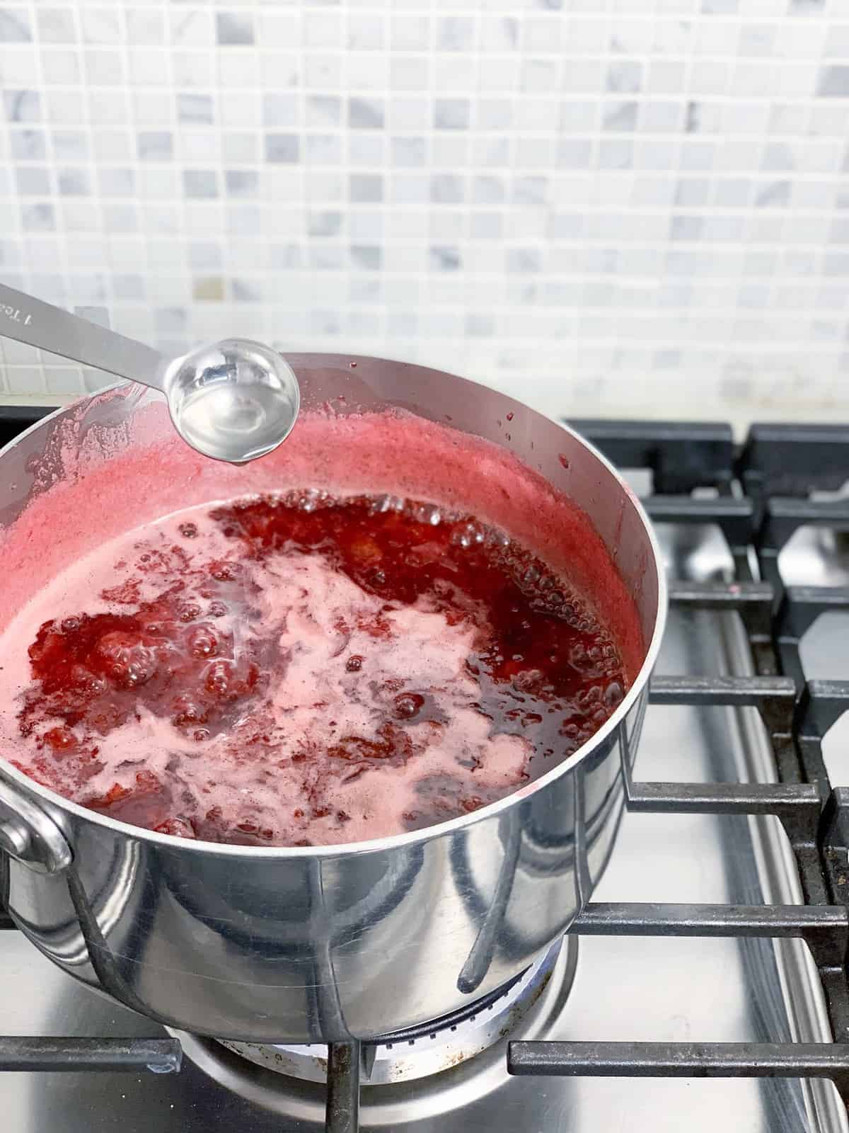 Once the sauce has simmered for 30 minutes, and has turned a deep red and thickened a bit, turn off the heat and add the almond extract, if you wish.