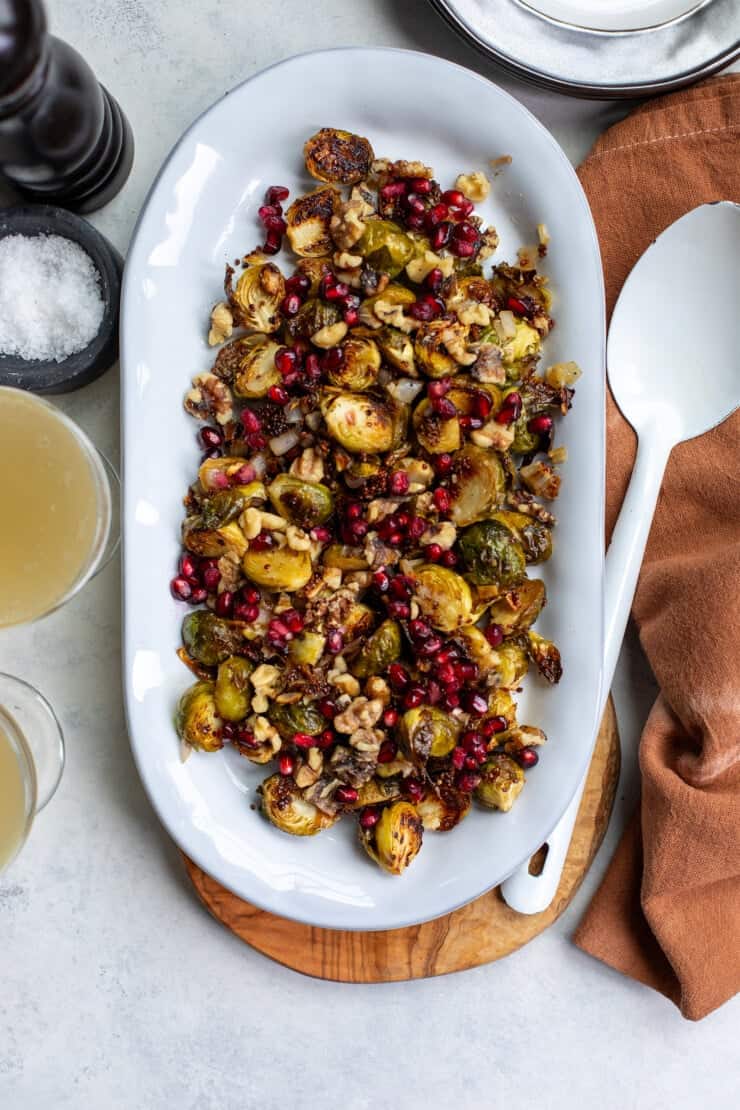 Roasted brussels sprouts on a white platter