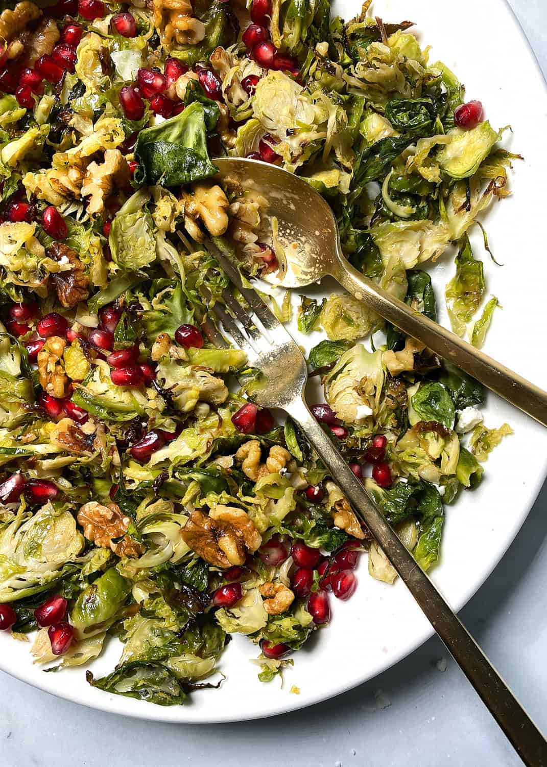 shaved brussels sprouts salad on a white platter