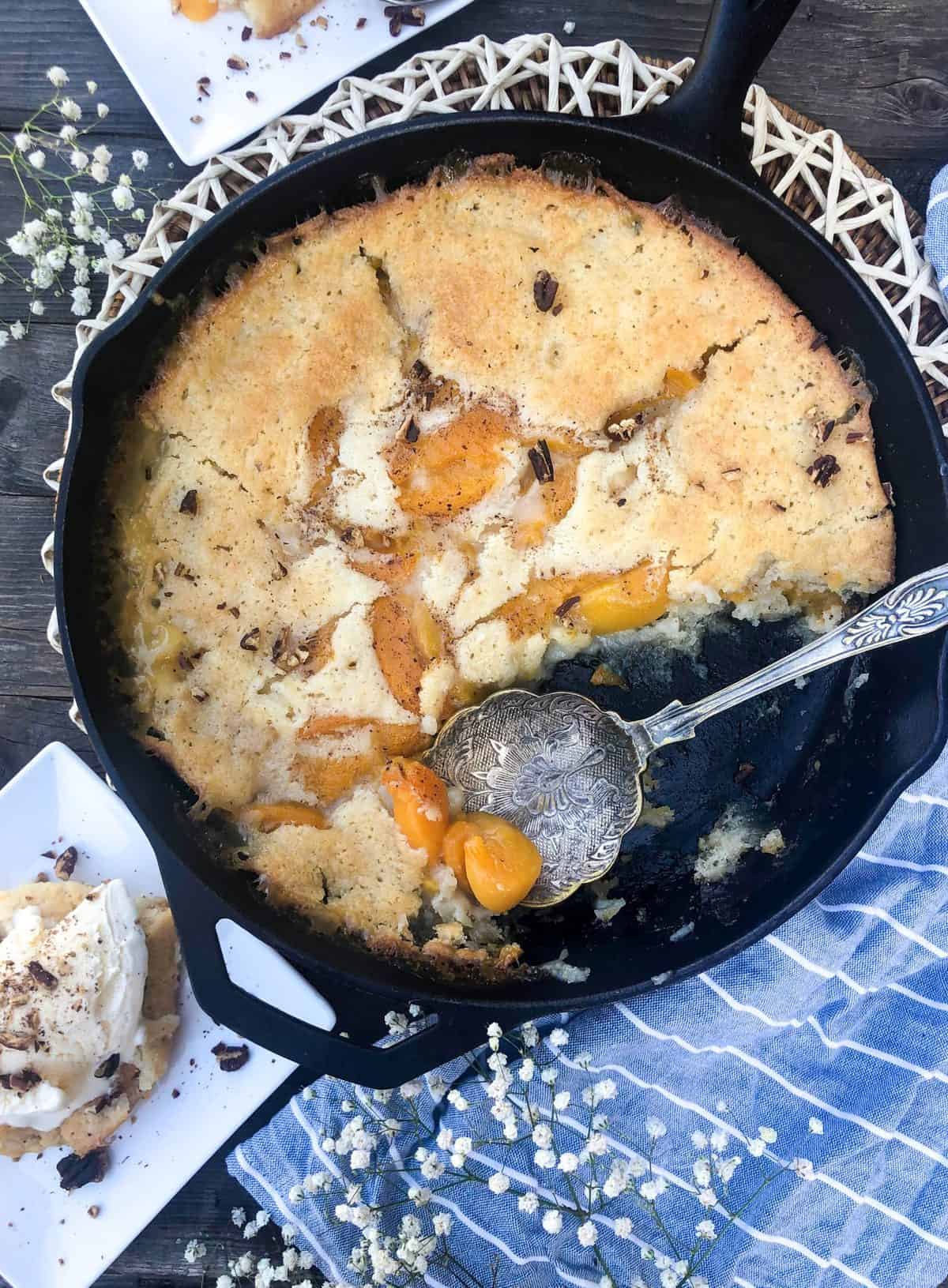canned peach cobbler with spoon in it
