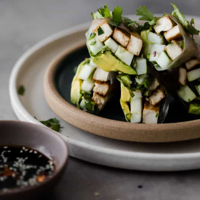 A close up of Cucumber Avocado Rolls stacked on a plate. 