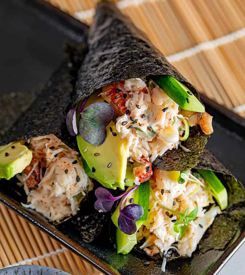 3 California hand rolls stacked on top of each other. This California avocados recipes is filled with crab and avocado. 