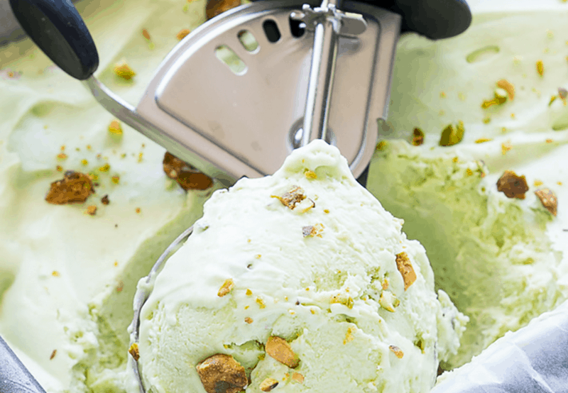 A close up of a scoop of avocado pistachio ice cream.
