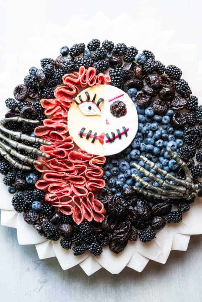 halloween food art cheesebaord - Nightmare before Christmas cheeseboard with prunes, berries, brie