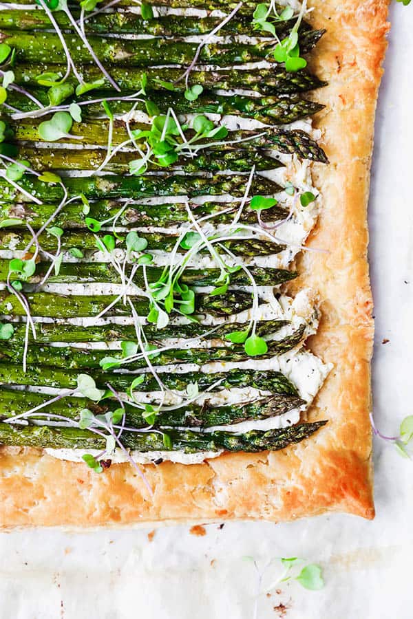 A Roasted Asparagus and Goat Cheese Tart topped with a sprinkle of micro greens. Roasting is one of the best ways to cook asparagus. 