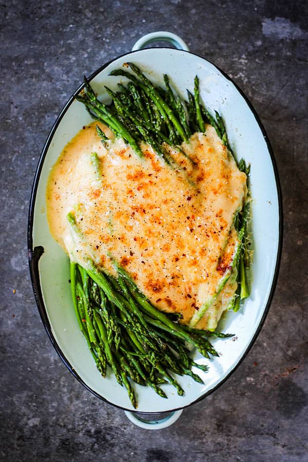Blanched asparagus topped with a rich cheese sauce and broiled into oven until golden brown