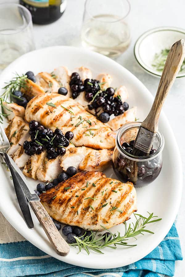 Grilled Chicken breasts with Blueberry Relish spooned over the top.