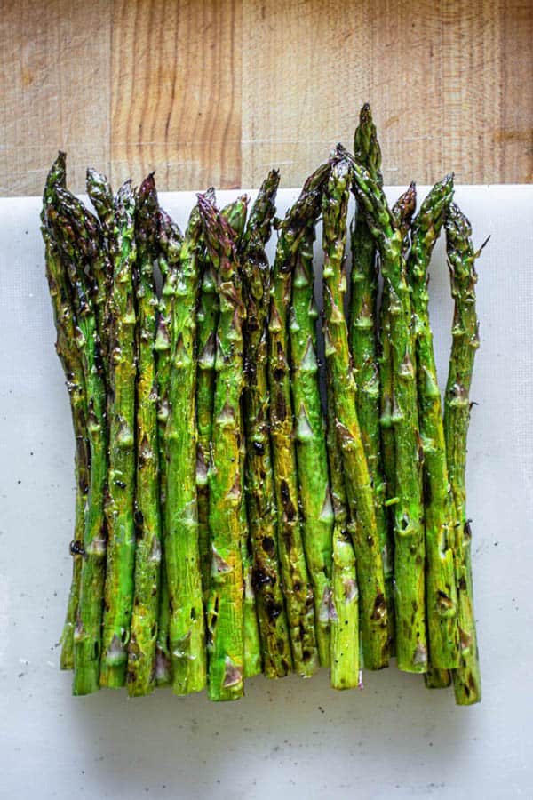 Asparagus fresh off the grill with woody stems removed.