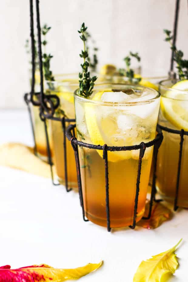 This is how to use honey! Make a honey sweetened cocktail in a glass with slices of lemon and sprigs of thyme.