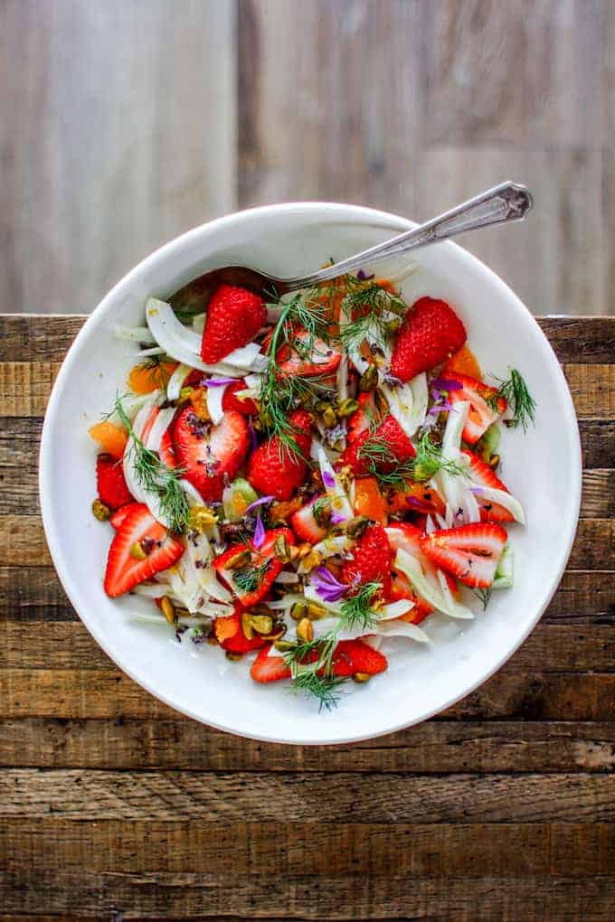 This is how to use honey, make a dressing for fruit salad. A winter fruit salad with strawberries, fennel, clementines, and honey.