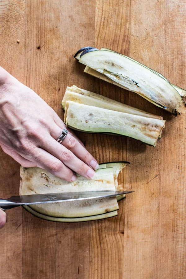 Slicing thin strips of eggplant in half