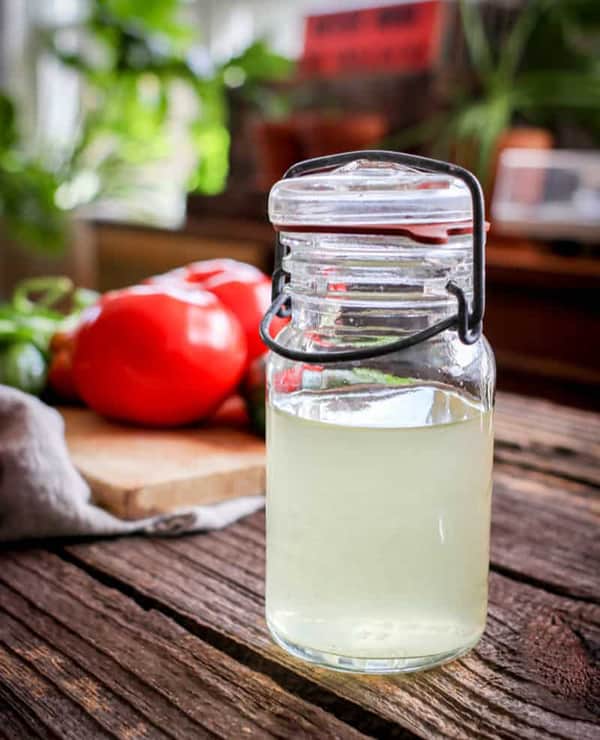 Clear tomato water in a small jar.