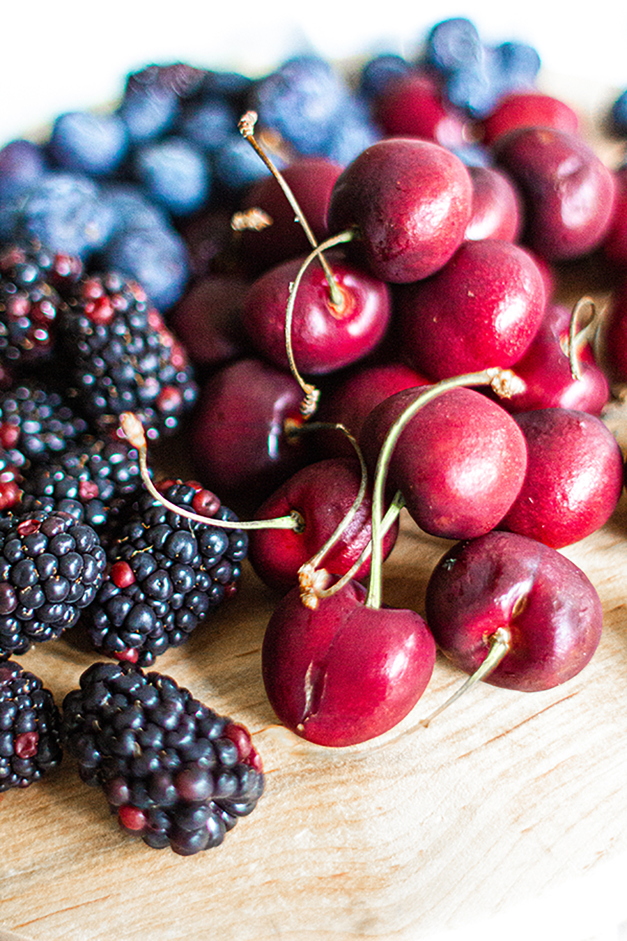 Cherries, blueberries, and blackberries for a popsicle recipe.