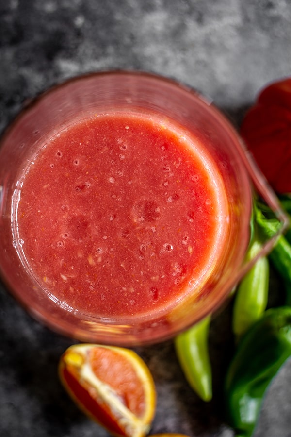 A close up of homemade bloody Mary mix in a pitcher.