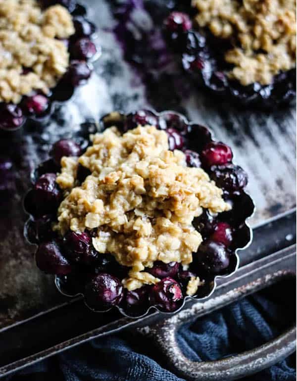 Individual blueberry crisps topped with an oat topping. 