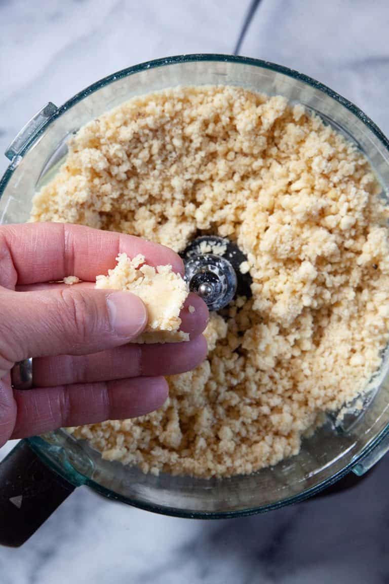 Ingredients to make a berry fig tart recipe in a food processor.