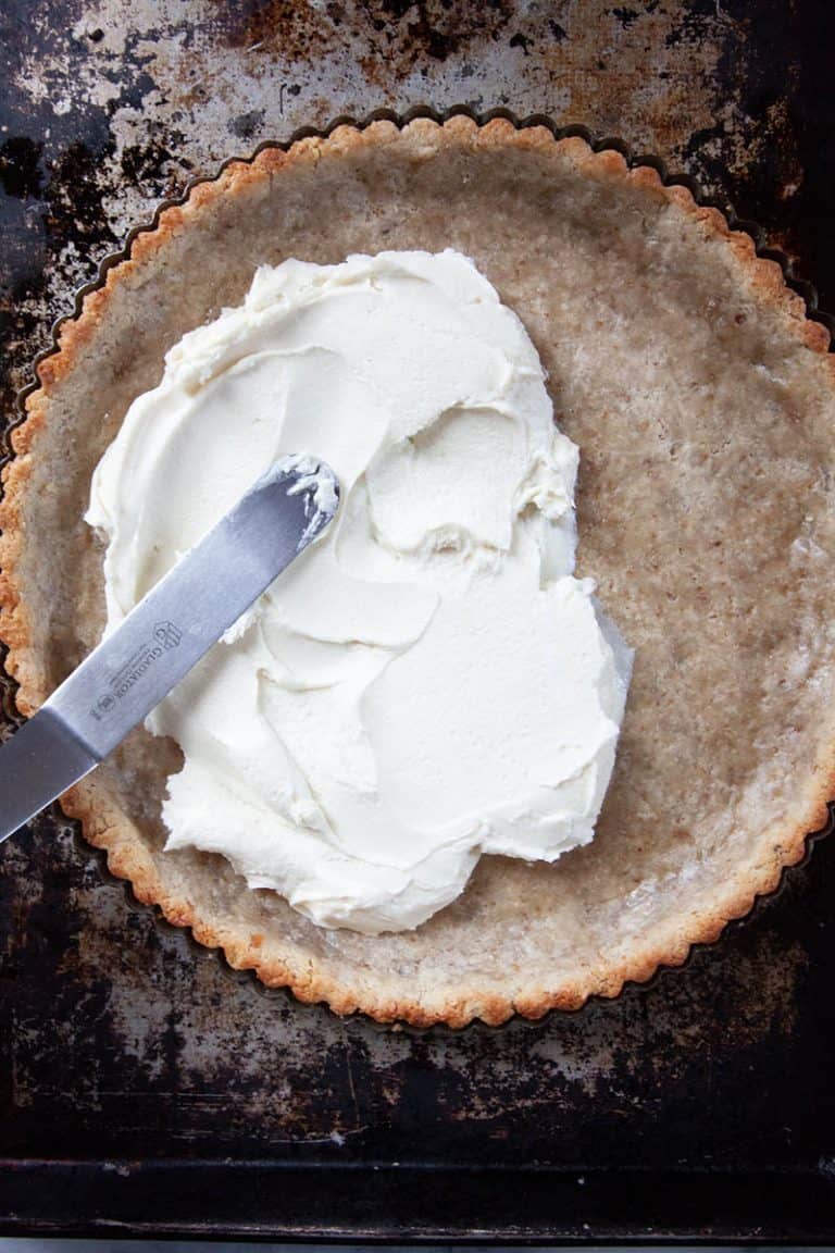 Tart recipe being covered in goat cheese.