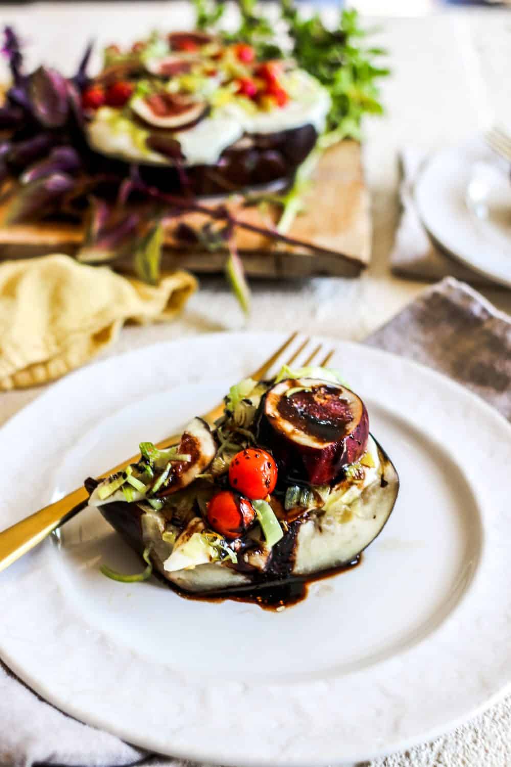 Slices of Baked Eggplant with California Figs and Leeks drizzled with balsamic reduction.