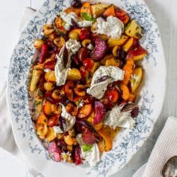 A large platter of stone fruit and burrata salad.