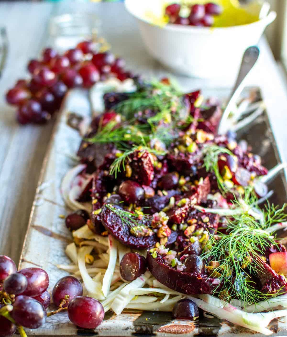 A platter of bright red Grape-Roasted Beet Salad drizzled with Serrano Pepper Dressing.