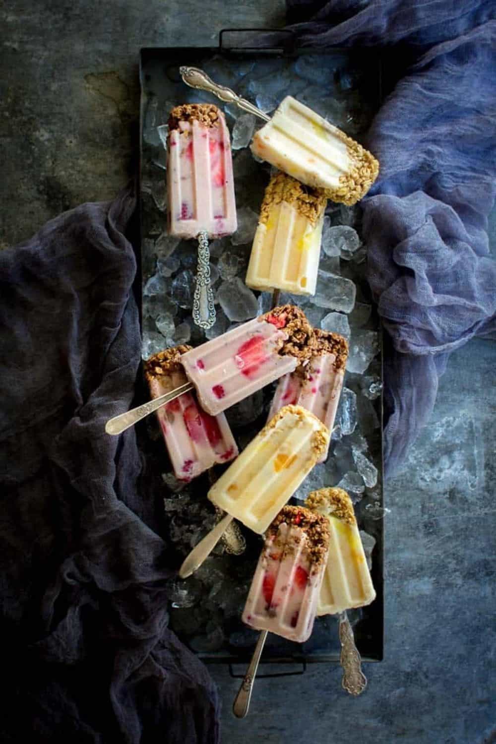 A tray of yogurt and granola popsicles.