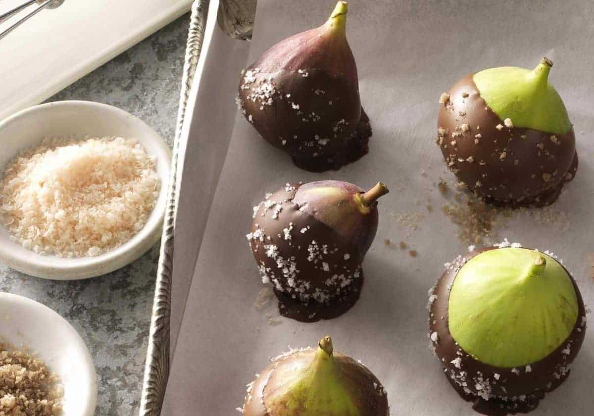 Fresh fig recipes like these Chocolate Covered Figs with sea salt are easy to make and look great! Green and purple figs are dipped halfway into chocolate then sprinkled with sea salt to finish.