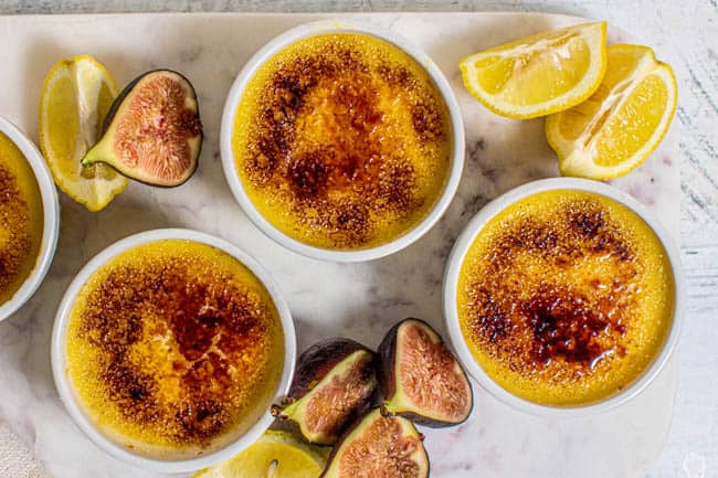 Four Fresh #Fig Compote and Easy Crème Brûlée in ramekins on top of a marble board.