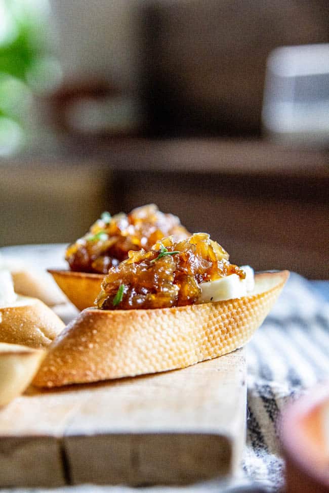 A close up of a crostini with sweet onion jam.