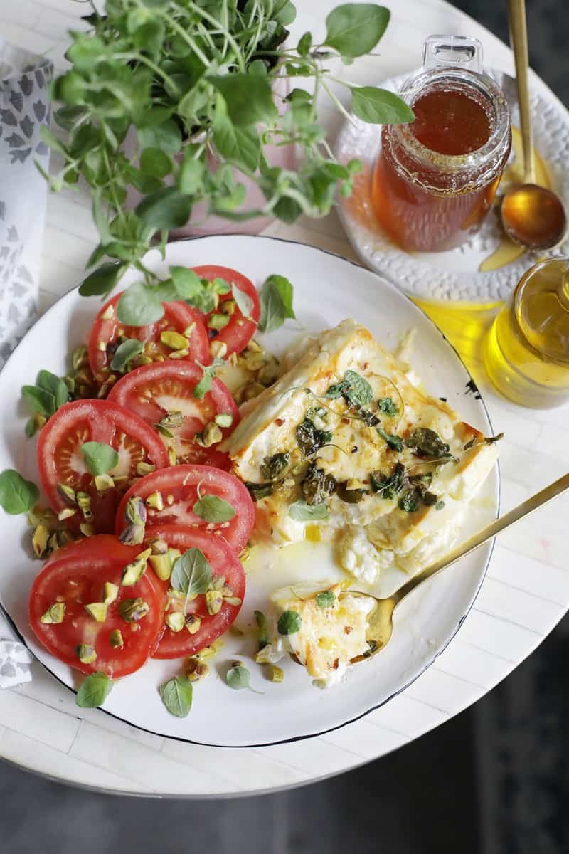 Honey and Oregano Broiled Feta Caprese from Salt and Wind is a delicious recipe for Happy Hour at Home