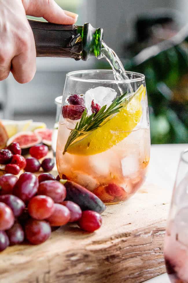 Sparkling wine being poured into a wine cocktail.