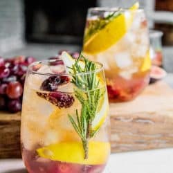 A glass of Rosemary and Roasted Grape Wine Cocktail