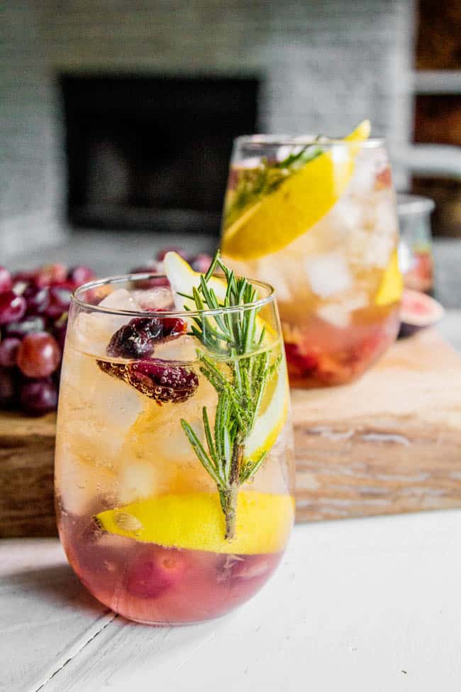 A glass of Rosemary and Roasted Grape Wine Cocktail