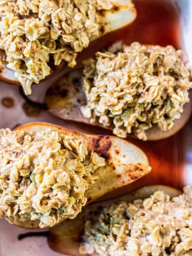 This Recipe for Baked Oatmeal Fig Stuffed Pears makes 4 stuffed pears. This image shows four of the finished pears in a baking dish.