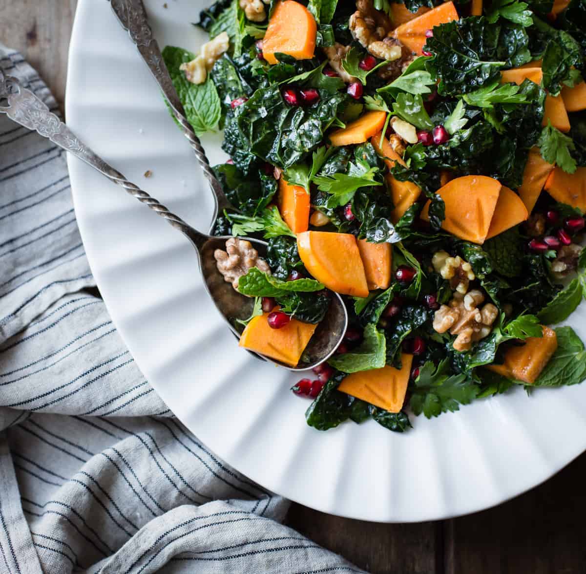 Herbed Kale Salad with Persimmon, Pomegranate, and Maple-Cumin Dressing