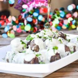 Saucy Thai-style Meatballs with Cilantro recipe prepared on a platter with New Years Eve celebrations behind