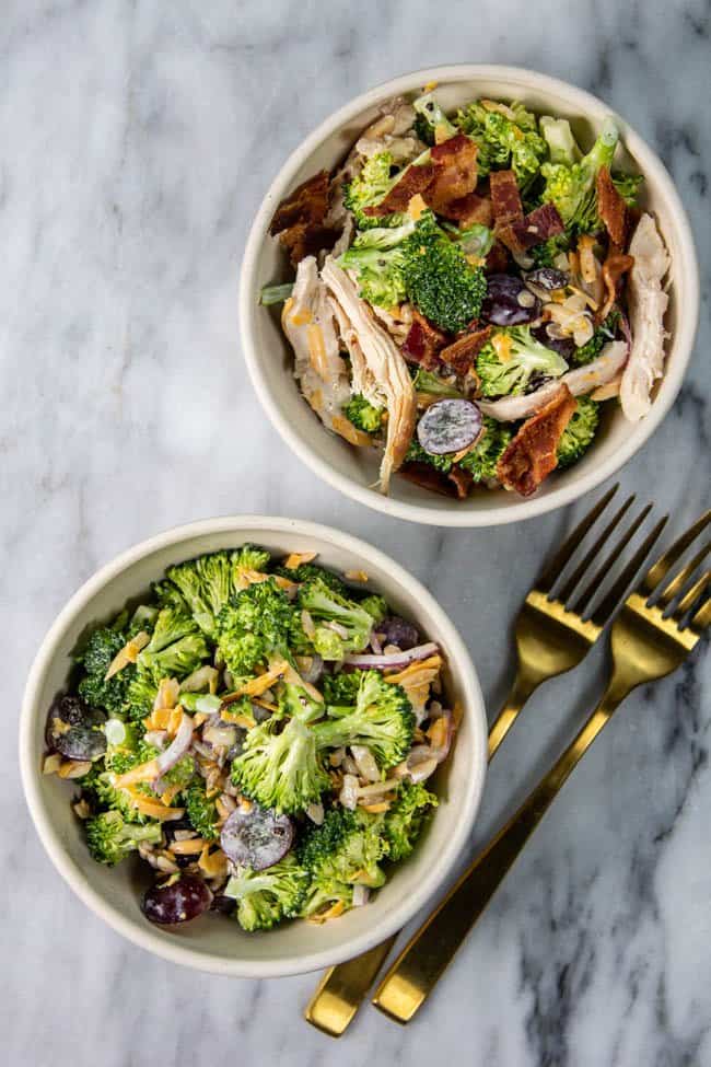 Two bowls of broccoli salad, one vegetarian and one with chicken and bacon.