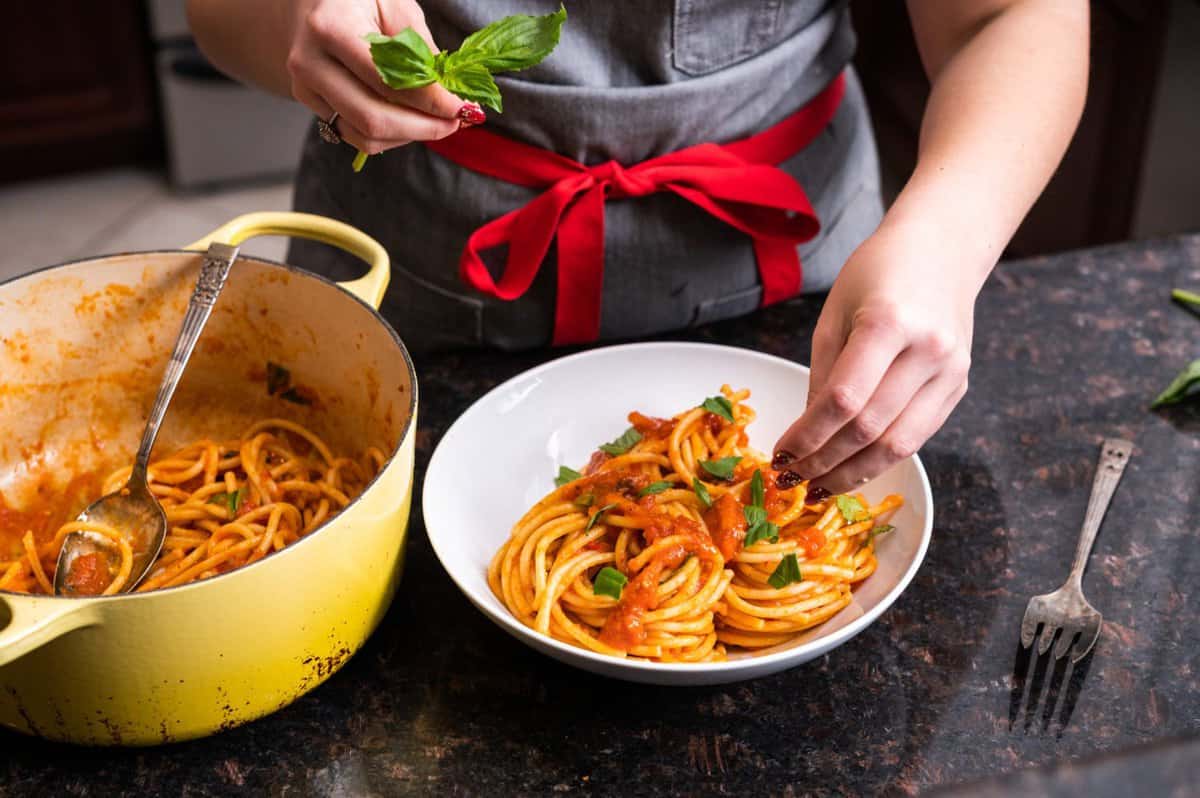 Woman making a special meal with Mezzetta Tomato Sauce