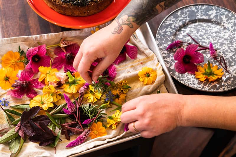 A woman working with edible flowers
