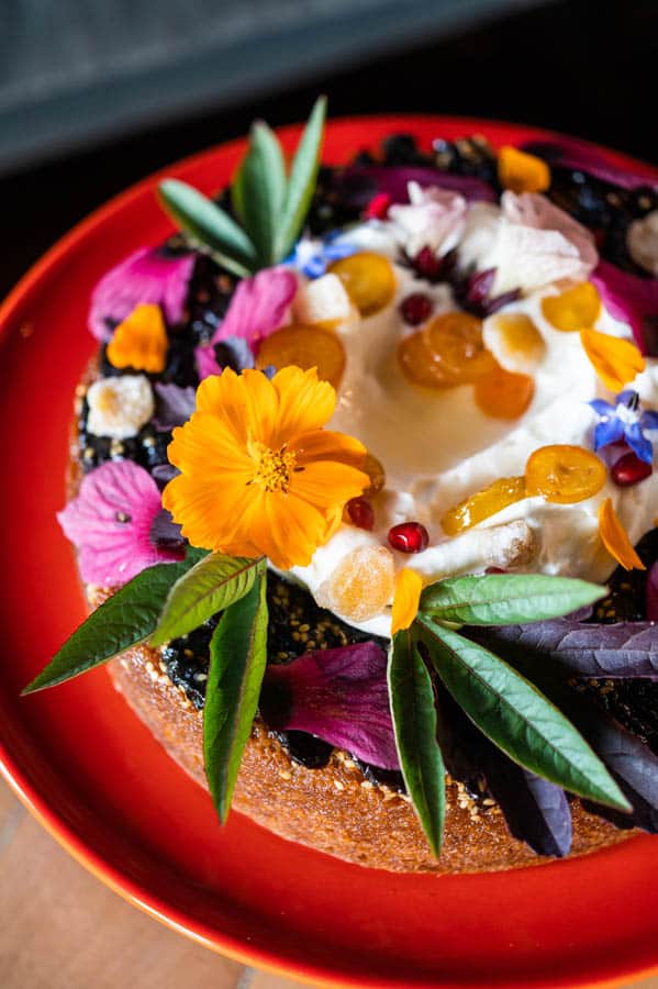 A cake covered in edible flowers