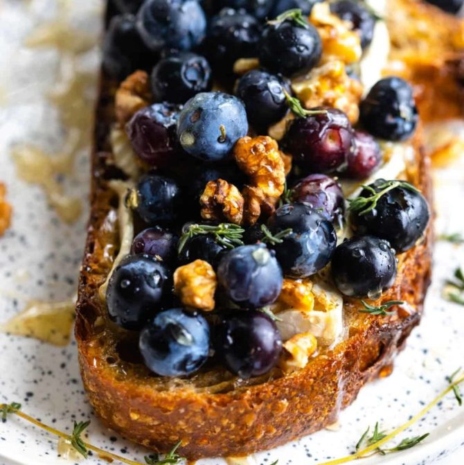 Ricotta Toast With Warmed Peaches Honey Blueberries And Walnuts