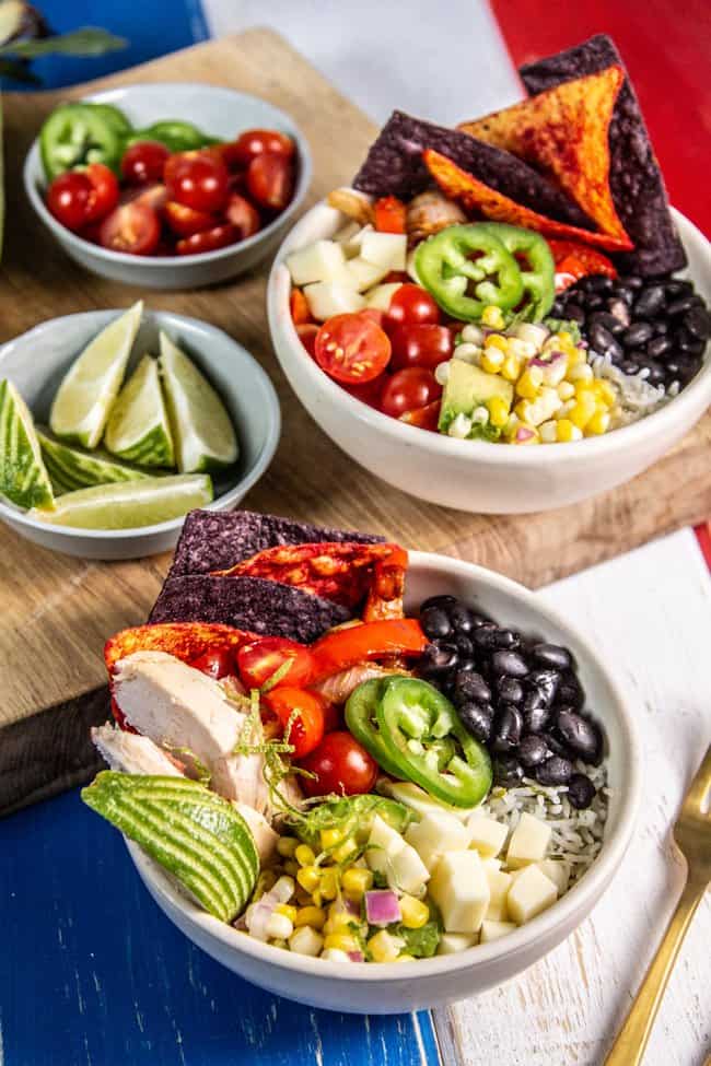 Burrito bowls with black beans, fajita veggies, cherry tomatoes, sweet corn and avocado salad.