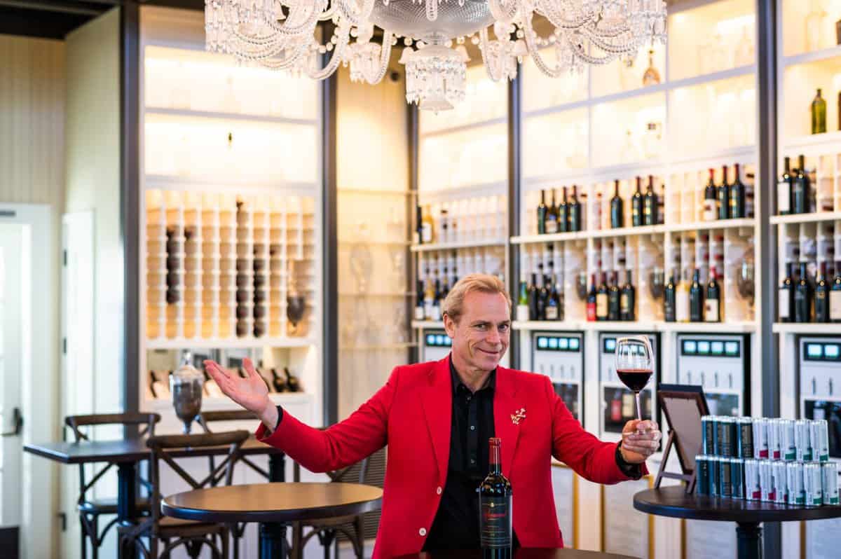 JC Boisset inside of Oakville Grocery with shelves of local wine in background