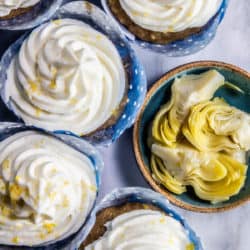 Lemon-Laced Artichoke Cupcakes next to a bowl of artichoke hearts.