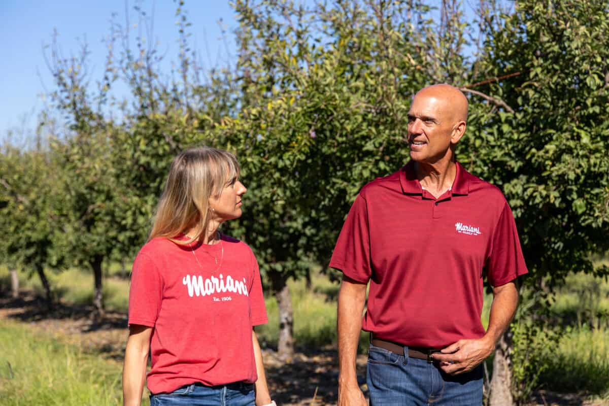George Souza and Natalie Mariani Kling walking through the Mariani Family Yuba City Prune Orchards