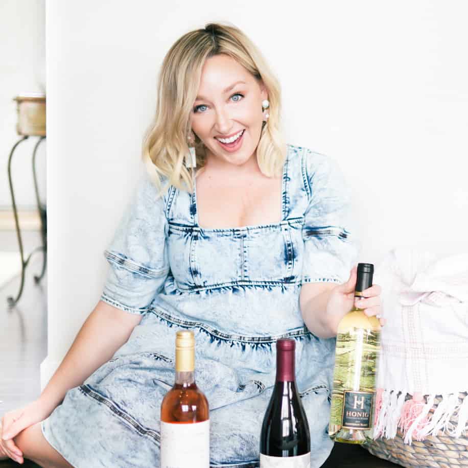 Amanda McCrossin holding a bottle of California Sauvignon Blanc