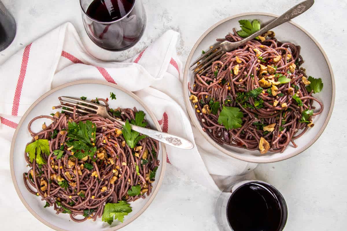 Two bowls of Red Wine Spaghetti on a table to serve.
